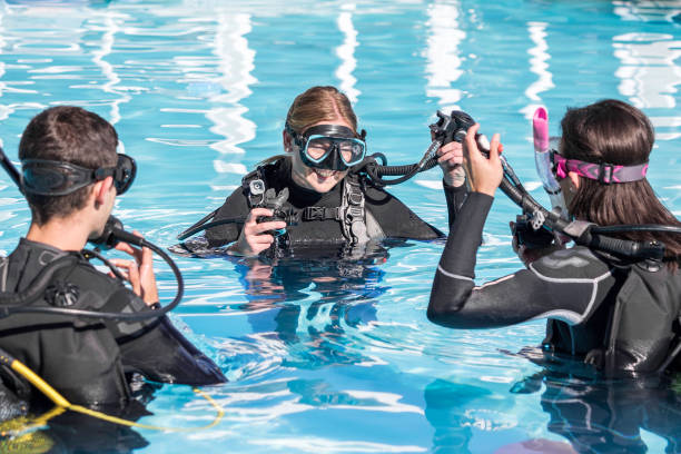 A group photo in scuba suits on the boat, with the scuba instructor giving instructions before the dive