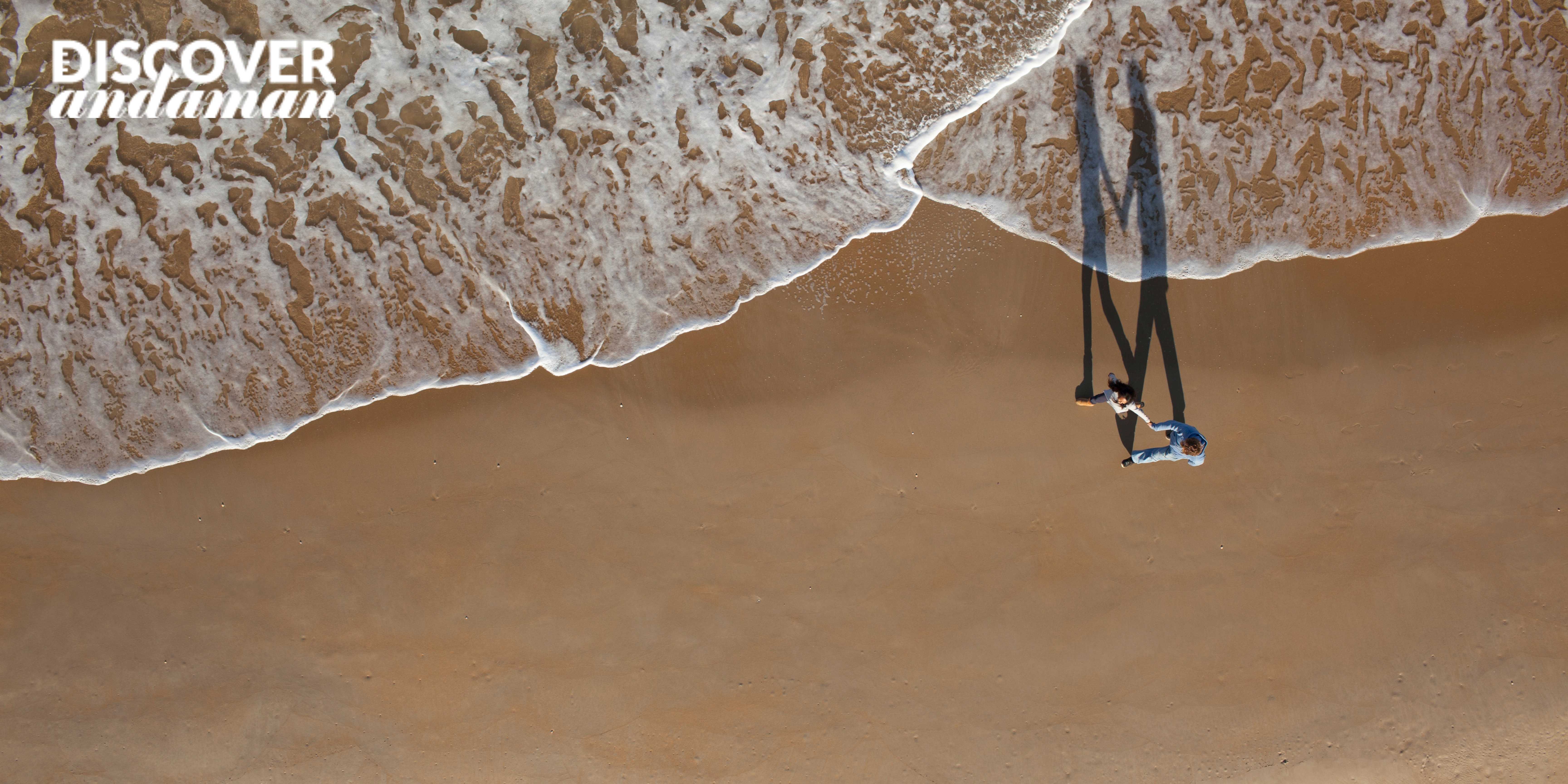 A couple walking on beach drone photoshoot .jpg