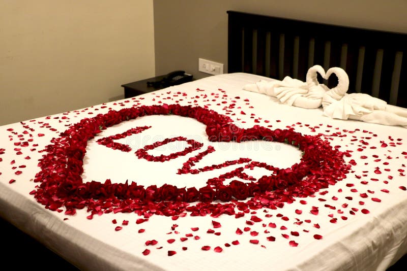 honeymoon-room-first-night-decoration-flower-petals-bed-215499739.jpg
